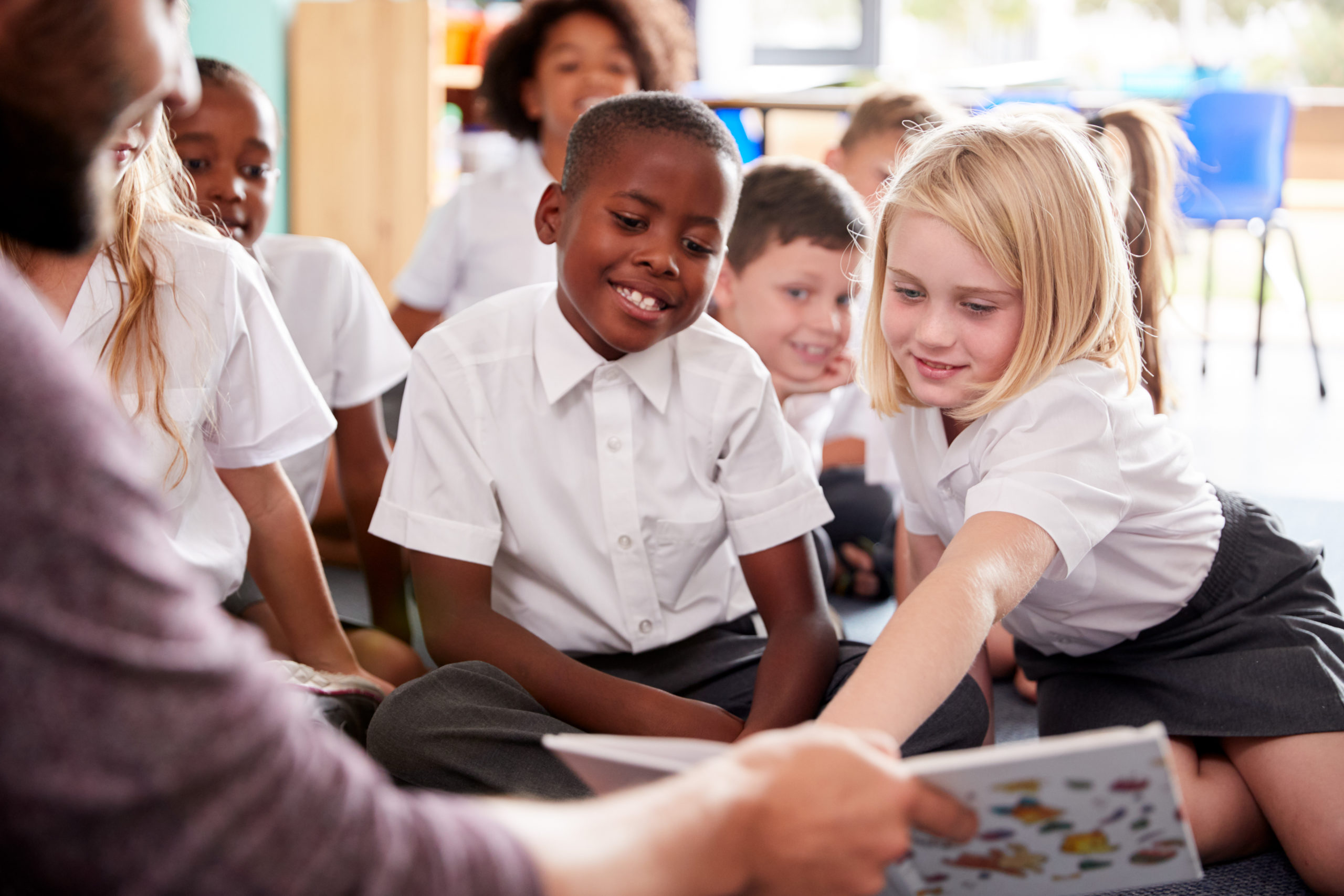 Children in a classroom attentively listening to a story